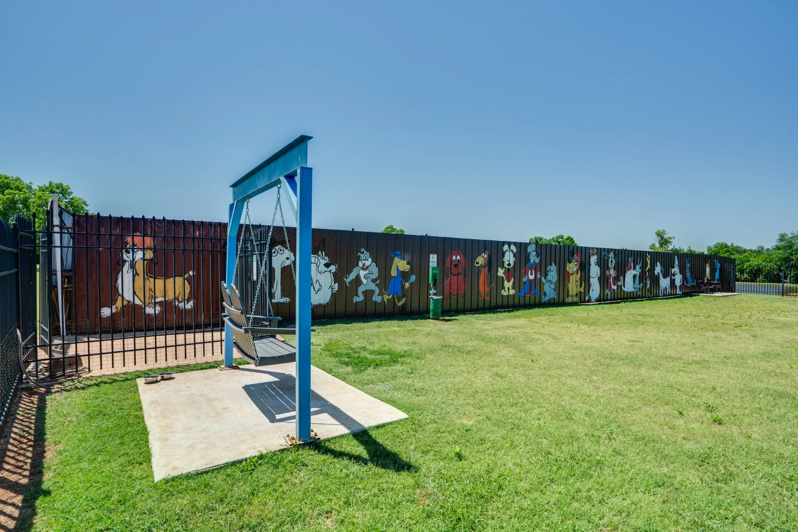 Fun at Wichita Falls RV Park Pet-friendly dog park at Wichita Falls RV Park features fenced play area, colorful murals, open space, and convenient pet exercise amenities.