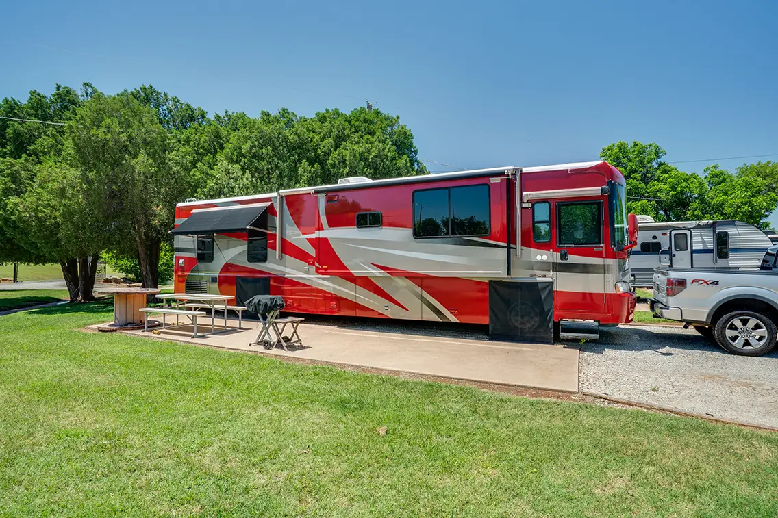 Airstream travel trailer at Wichita Falls RV Park with spacious shaded campsite, full hookups, peaceful setting, and convenient access to local attractions.